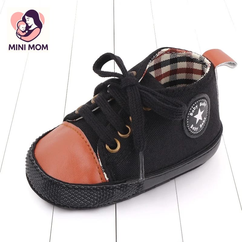 Black high-top sneaker with brown soles on a white background, featuring the Mini Mom brand.