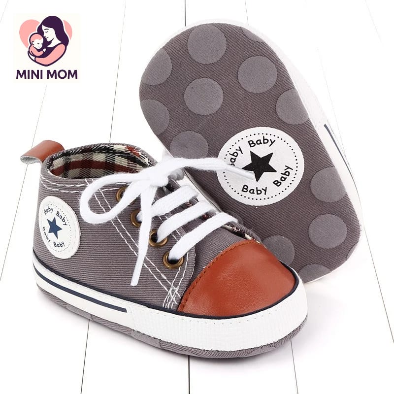 Baby sneakers with polka dot soles and visible brand logo on a white background