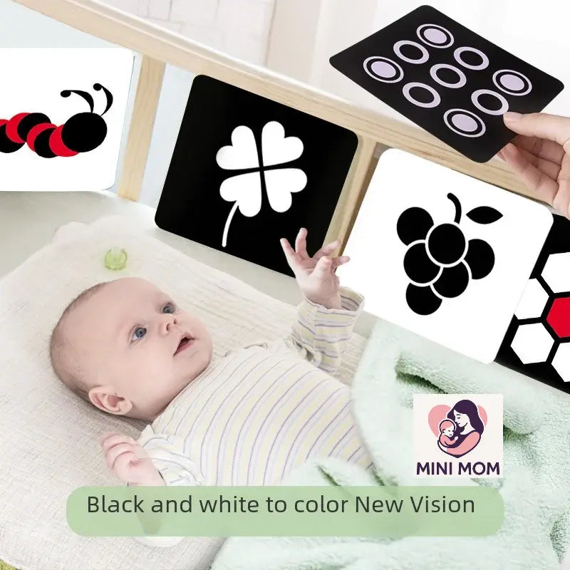 Baby lying on a blanket with educational cards featuring shapes and patterns, with 'MINI MOM' branding.