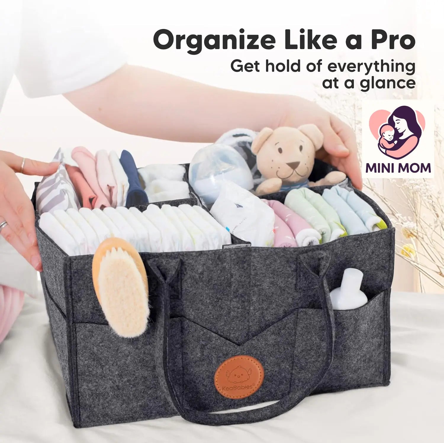 Gray diaper organizer bag filled with baby items with 'MINI MOM' branding.