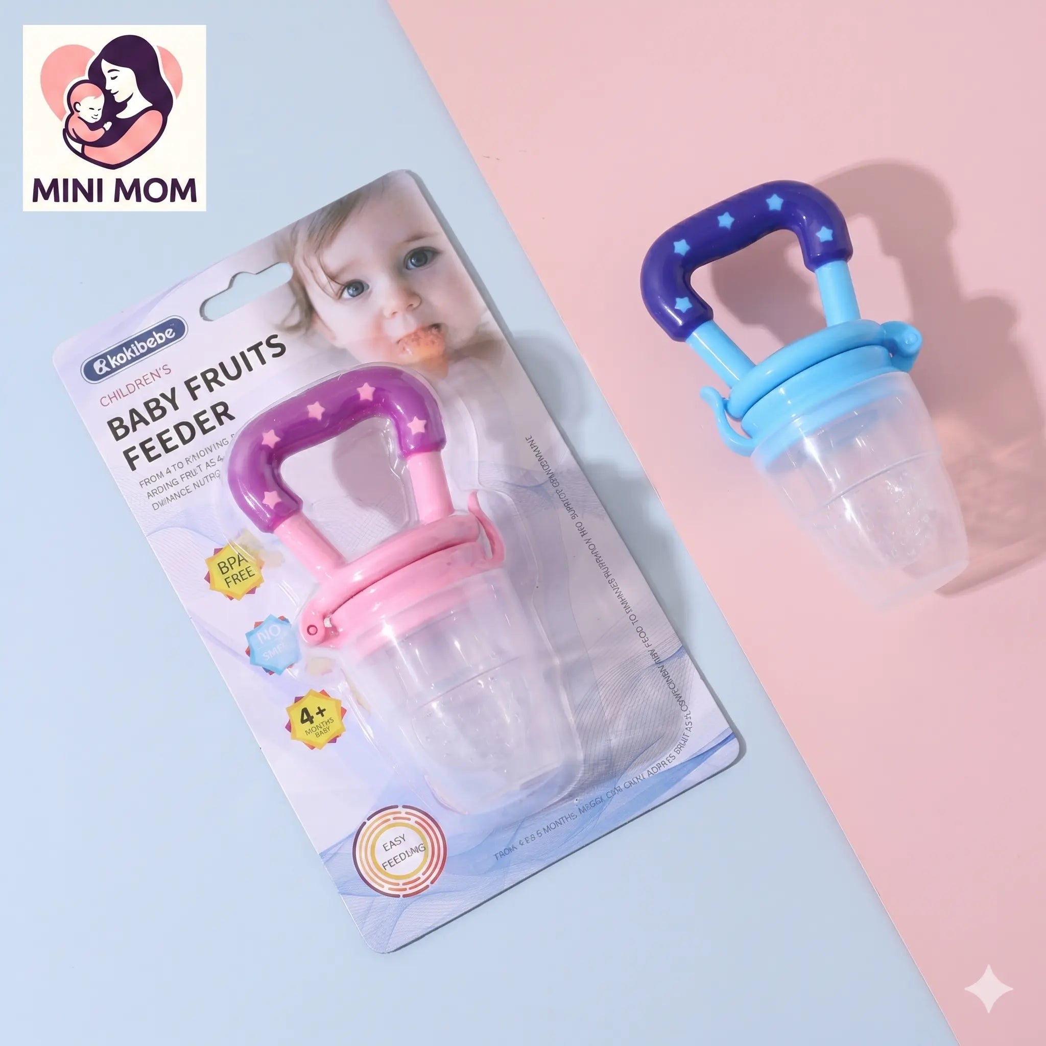 Baby fruit feeder with packaging on a light blue and pink background, featuring the brand 'Mini Mom'.