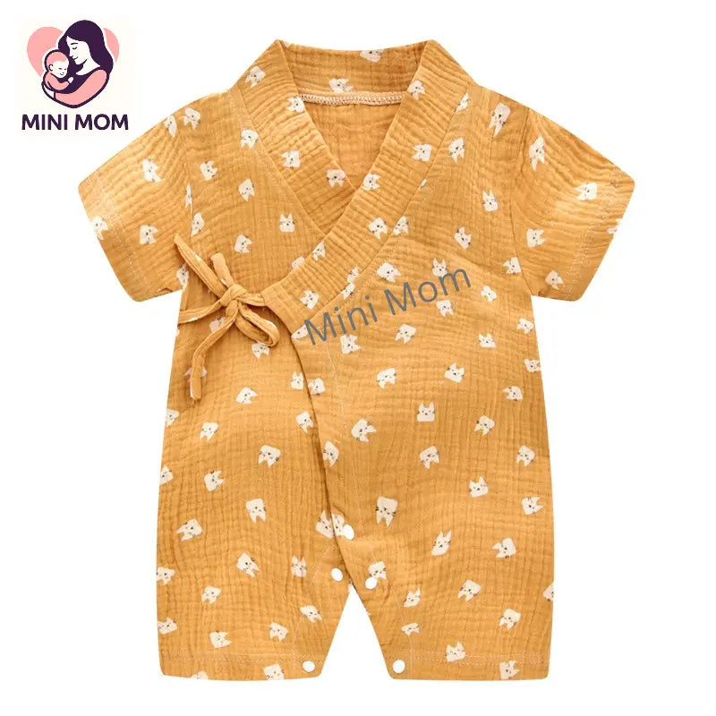 Yellow baby romper with white patterns on a white background, branded 'Mini Mom'.
