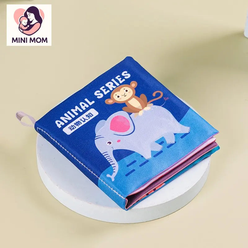 Children's book with animal illustrations on a beige background, featuring the brand 'MINI MOM'.