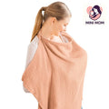 Woman wearing a peach-colored baby wrap with 'Mini Mom' logo in the corner