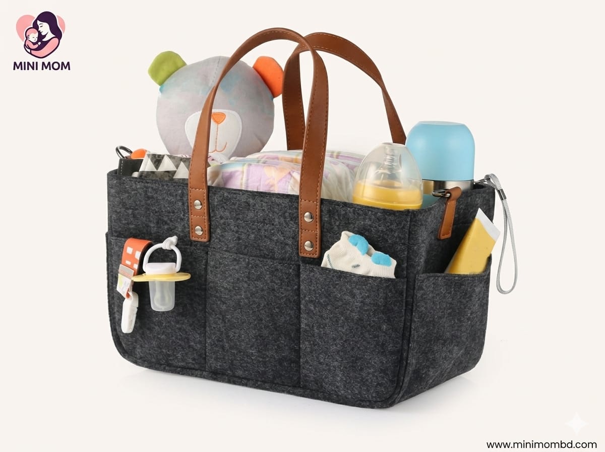 Black diaper bag with brown straps filled with baby items on a white background, featuring the Mini Mom brand.