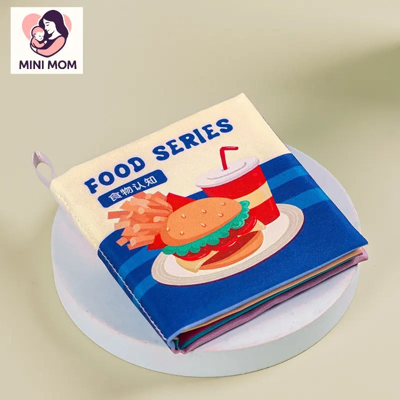 Children's book with food illustrations on a light background, featuring the brand 'MINI MOM'.