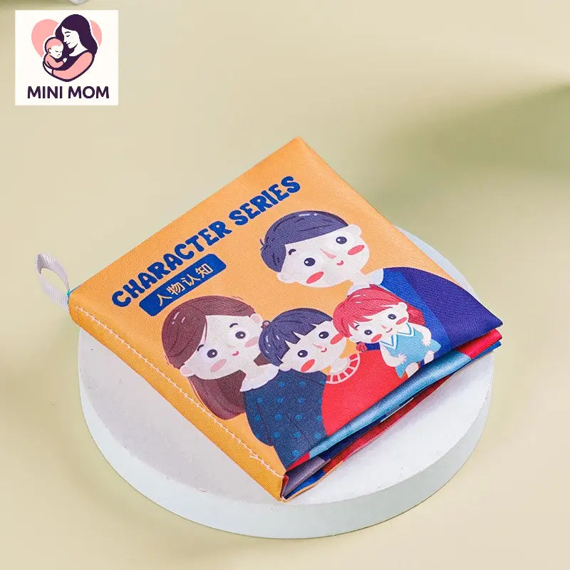 soft baby cloth book with cartoon characters on an orange background, featuring the 'MINI MOM' brand.