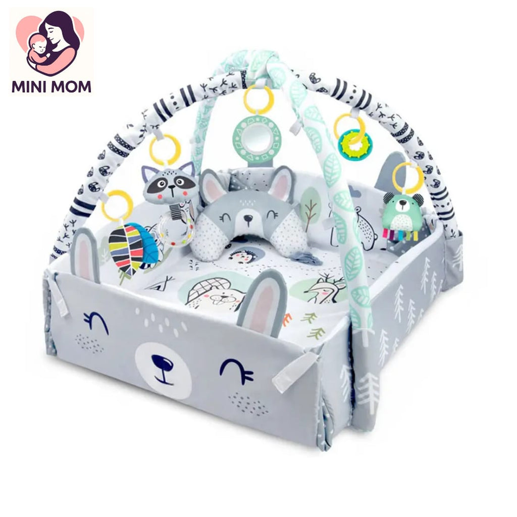 Baby play gym with toys and plush animals on a white background, featuring the brand 'Mini Mom'.