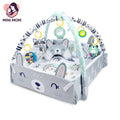 Baby play gym with toys and plush animals on a white background, featuring the brand 'Mini Mom'.