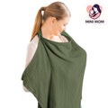 Woman wearing a green baby wrap carrier with 'Mini Mom' logo in the corner.
